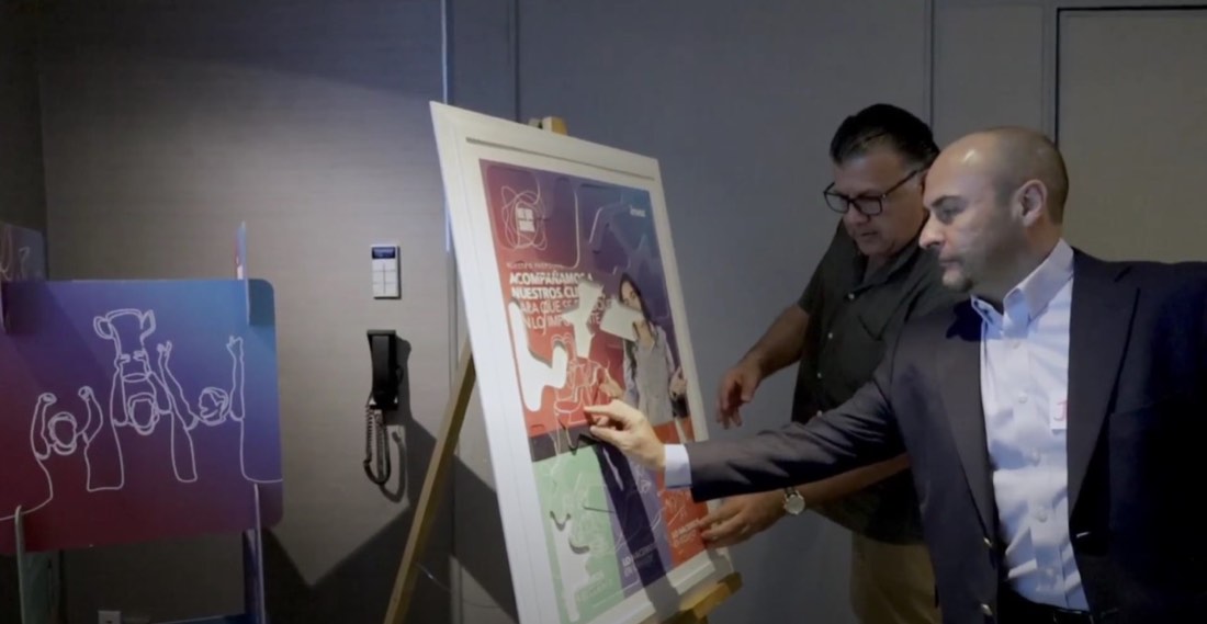 Colaboradores de Invex firmando un mural durante la activación de comunicación interna